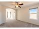 Well-lit bedroom with carpet flooring and ceiling fan at 3433 E Francisco Dr, Phoenix, AZ 85042