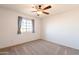 Cozy bedroom with ceiling fan and a window with curtains at 3433 E Francisco Dr, Phoenix, AZ 85042