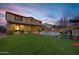 Large backyard with pool, grass, and playset at 3457 E Virgil Dr, Gilbert, AZ 85298