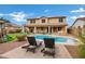 Relaxing backyard oasis featuring a pool, patio furniture, and lush landscaping at 3457 E Virgil Dr, Gilbert, AZ 85298