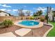 Stunning kidney-shaped pool surrounded by a stone patio and landscaping at 3457 E Virgil Dr, Gilbert, AZ 85298