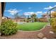 Landscaped backyard with artificial turf, playground, and pool at 3457 E Virgil Dr, Gilbert, AZ 85298