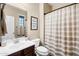 Clean bathroom with a striped shower curtain and dark vanity at 3457 E Virgil Dr, Gilbert, AZ 85298