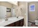 Bathroom with double sinks and dark wood cabinets at 3457 E Virgil Dr, Gilbert, AZ 85298