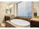 Elegant bathroom with soaking tub, double vanity, and walk-in shower at 3457 E Virgil Dr, Gilbert, AZ 85298