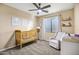 Bedroom with crib, recliner, and window coverings at 3457 E Virgil Dr, Gilbert, AZ 85298