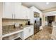 Well-equipped kitchen with granite counters, stainless steel appliances, and built-in desk at 3457 E Virgil Dr, Gilbert, AZ 85298