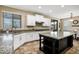 Modern kitchen with granite countertops, stainless steel appliances, and an island at 3457 E Virgil Dr, Gilbert, AZ 85298
