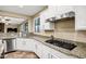 Kitchen boasts granite counters, stainless steel appliances, and white cabinets at 3457 E Virgil Dr, Gilbert, AZ 85298