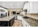 Open concept kitchen with island, granite countertops, and stainless steel appliances at 3457 E Virgil Dr, Gilbert, AZ 85298