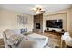 Spacious living room with a stone fireplace and large TV at 3457 E Virgil Dr, Gilbert, AZ 85298