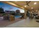 Covered patio with outdoor kitchen and pool view at 3457 E Virgil Dr, Gilbert, AZ 85298