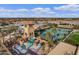 Relaxing pool area with water slide, rock formations, and adjacent tennis courts at 3457 E Virgil Dr, Gilbert, AZ 85298