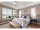 Spacious main bedroom with a large bed, plenty of natural light and a ceiling fan at 36709 N Stoneware Dr, San Tan Valley, AZ 85140