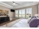 Main bedroom with large windows, hardwood floors, and a ceiling fan at 36709 N Stoneware Dr, San Tan Valley, AZ 85140