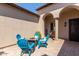 Private courtyard with blue chairs and fire pit at 36709 N Stoneware Dr, San Tan Valley, AZ 85140