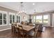 Bright dining room with a farmhouse table and large windows at 36709 N Stoneware Dr, San Tan Valley, AZ 85140