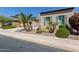 Tan stucco home with palm trees, drought-tolerant landscaping, and a two car garage at 36709 N Stoneware Dr, San Tan Valley, AZ 85140