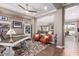 Home office with a large desk, built-in shelves, and two orange armchairs at 36709 N Stoneware Dr, San Tan Valley, AZ 85140