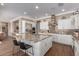 Spacious kitchen with granite island, stainless steel appliances, and white cabinetry at 36709 N Stoneware Dr, San Tan Valley, AZ 85140