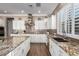 Modern kitchen featuring granite countertops, white cabinets, and a large island at 36709 N Stoneware Dr, San Tan Valley, AZ 85140