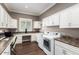 Bright laundry room with built-in workspace and modern appliances at 36709 N Stoneware Dr, San Tan Valley, AZ 85140