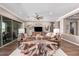 Living area with large windows and a stunning wood coffee table at 36709 N Stoneware Dr, San Tan Valley, AZ 85140