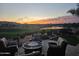 Relaxing patio seating area with fire pit and sunset view at 36709 N Stoneware Dr, San Tan Valley, AZ 85140