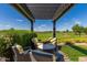 Pergola with seating area overlooking golf course at 36709 N Stoneware Dr, San Tan Valley, AZ 85140