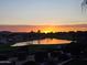 Beautiful lake view with the sun just rising over the homes and trees at 36709 N Stoneware Dr, San Tan Valley, AZ 85140