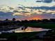 Beautiful lake view with an amazing Arizona sunset reflecting in the water and sky at 36709 N Stoneware Dr, San Tan Valley, AZ 85140