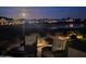 Patio view of the property overlooking the lake and golf course under the moonlight at 36709 N Stoneware Dr, San Tan Valley, AZ 85140
