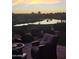 Patio view of the property overlooking the lake and golf course at sunrise at 36709 N Stoneware Dr, San Tan Valley, AZ 85140