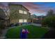 Spacious backyard with artificial turf, patio, and play equipment at 3743 W Wayne Ln, Anthem, AZ 85086