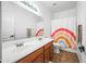 Clean bathroom with double sinks and rainbow shower curtain at 3743 W Wayne Ln, Anthem, AZ 85086