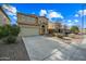 Two-story house with tan exterior, shutters, and a two-car garage at 3743 W Wayne Ln, Anthem, AZ 85086