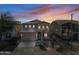 Two-story house with attached garage, desert landscaping, and sunset view at 3743 W Wayne Ln, Anthem, AZ 85086