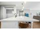 Modern kitchen island with seating and a view into the living room at 3743 W Wayne Ln, Anthem, AZ 85086