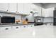 White kitchen with gray countertops and patterned backsplash at 3743 W Wayne Ln, Anthem, AZ 85086