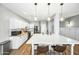 Modern kitchen with white cabinets, large island, and stainless steel appliances at 3743 W Wayne Ln, Anthem, AZ 85086