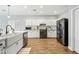 Modern kitchen with white cabinets, farmhouse sink, and stainless steel appliances at 3743 W Wayne Ln, Anthem, AZ 85086