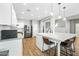 Modern kitchen with white cabinets, large island, and stainless steel appliances at 3743 W Wayne Ln, Anthem, AZ 85086