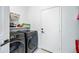 Bright laundry room with washer, dryer, and storage at 3743 W Wayne Ln, Anthem, AZ 85086