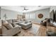 Cozy living room with hardwood floors, sectional sofa and a ceiling fan at 3743 W Wayne Ln, Anthem, AZ 85086