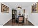 Formal dining room with dark wood table and chairs, hardwood floors, and large windows at 4122 S 185Th Ln, Goodyear, AZ 85338