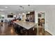 Island kitchen with dark cabinets, granite countertops, and breakfast bar at 4122 S 185Th Ln, Goodyear, AZ 85338