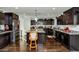 Spacious kitchen with dark cabinetry, granite countertops, and island at 4122 S 185Th Ln, Goodyear, AZ 85338