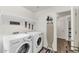 Bright laundry room featuring a washer, dryer, and ample shelving at 4122 S 185Th Ln, Goodyear, AZ 85338