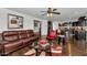 Open concept living room with kitchen access and leather couch at 4122 S 185Th Ln, Goodyear, AZ 85338