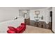 Loft hallway with dark hardwood floors and a red chaise lounge at 4122 S 185Th Ln, Goodyear, AZ 85338